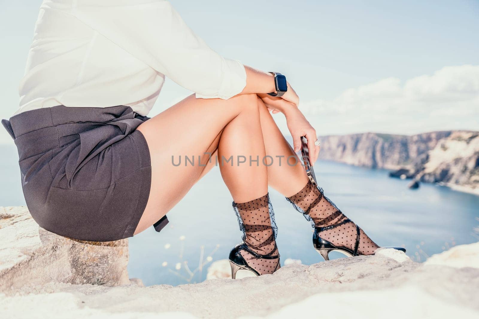 Woman sea laptop. Business woman in yellow hat freelancer with laptop working over blue sea beach. Girl relieves stress from work. Freelance, digital nomad, travel and holidays concept by panophotograph