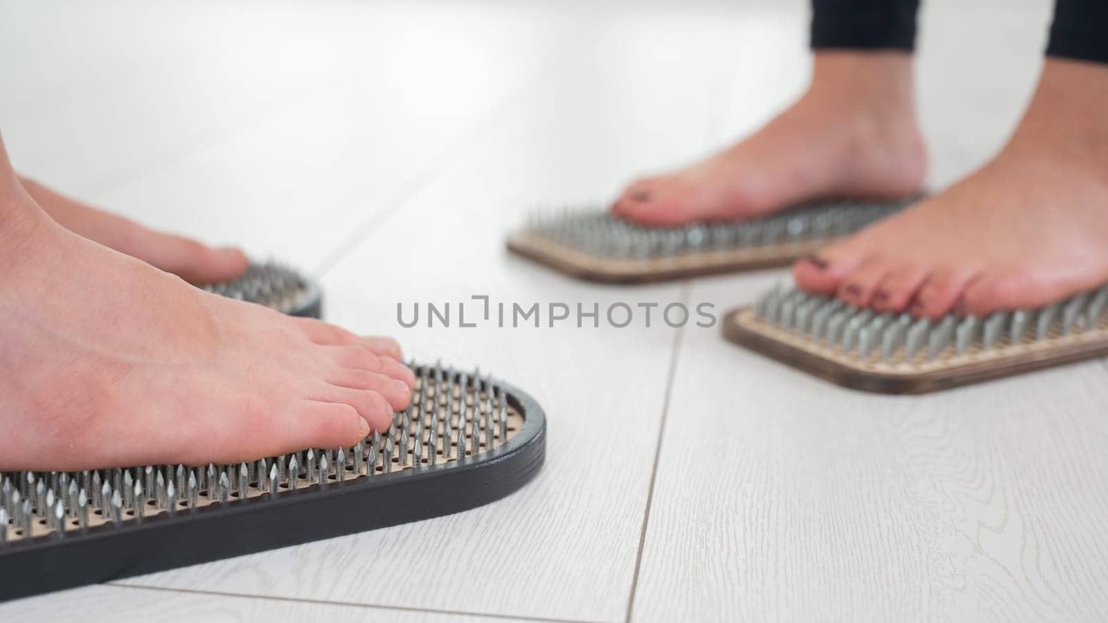 Caucasian and Asian women stand up sadhu boards together