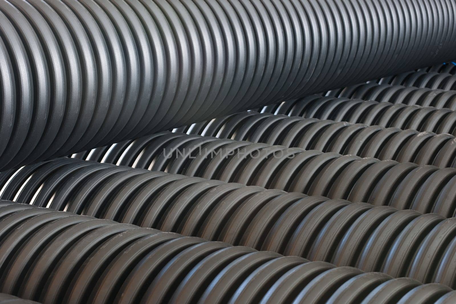 Bunches of PVC pipe sitting on palets at a wholesale pipe store.