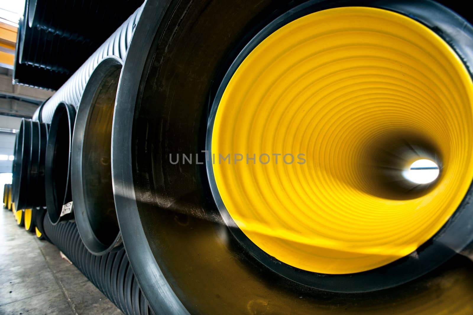 Bunches of PVC pipe sitting on palets at a wholesale pipe store.