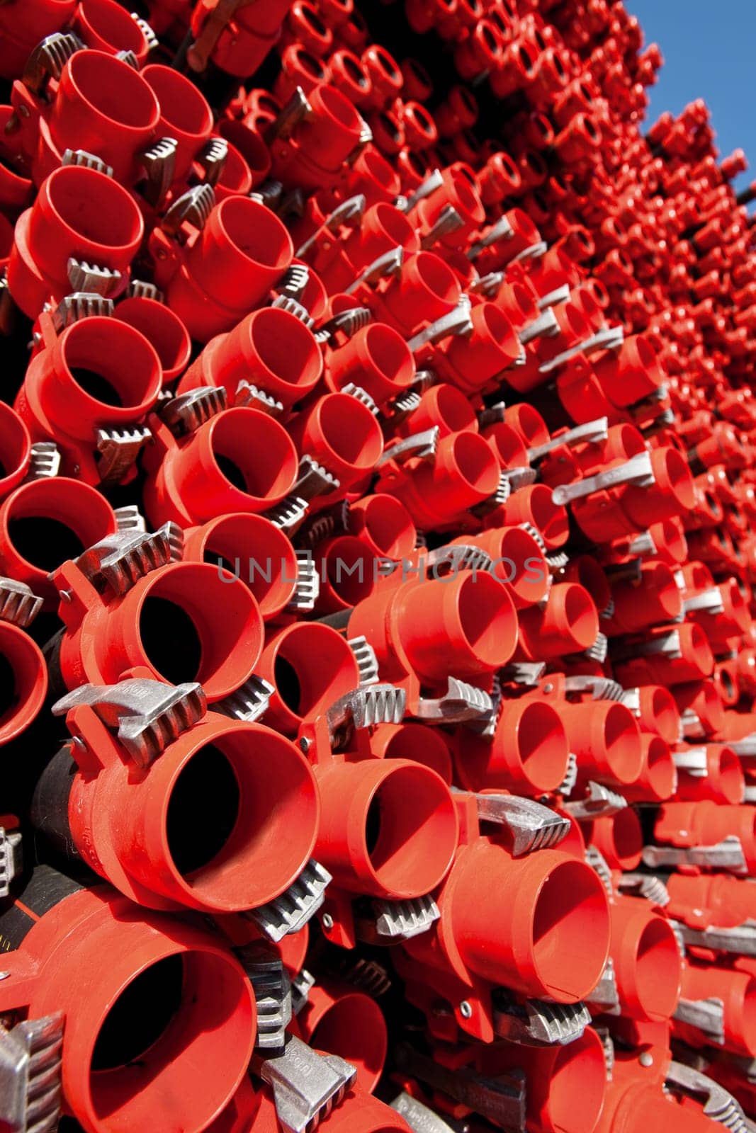 Bunches of PVC pipe sitting on palets at a wholesale pipe store.