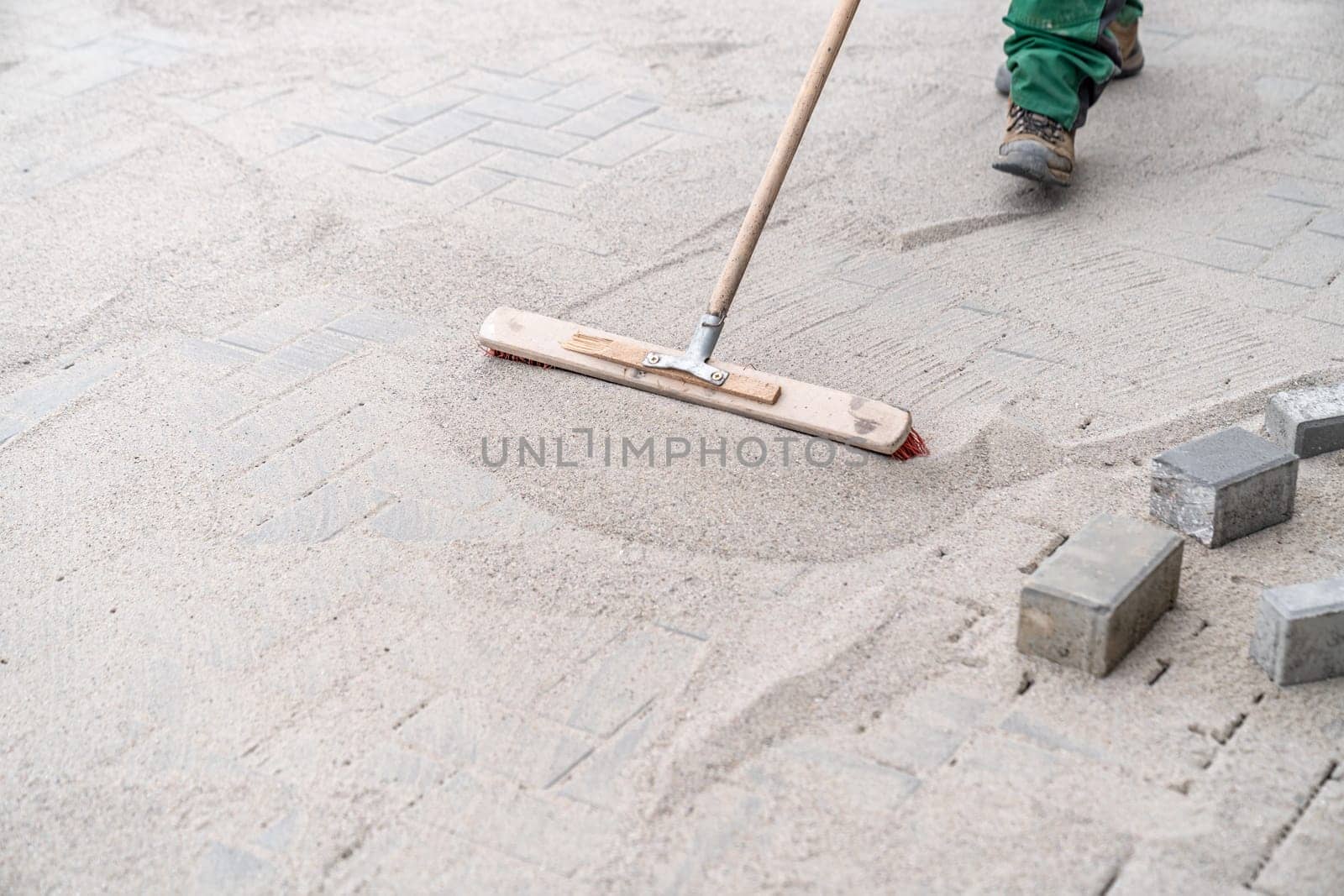 filling the gaps in the new pavement with sand.