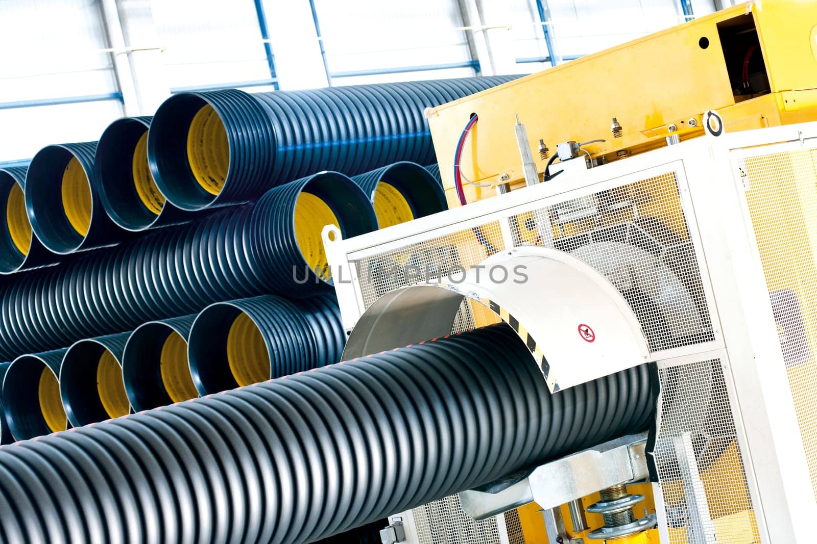 Bunches of PVC pipe sitting on palets at a wholesale pipe store.