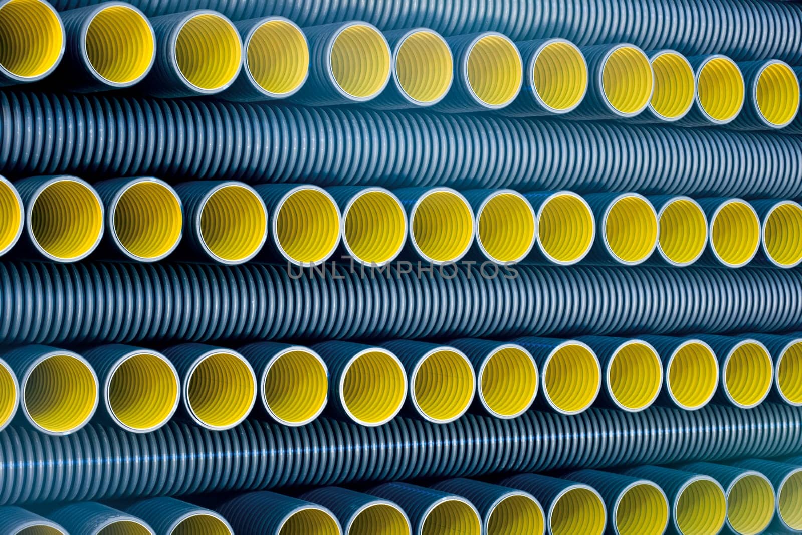 Bunches of PVC pipe sitting on palets at a wholesale pipe store.