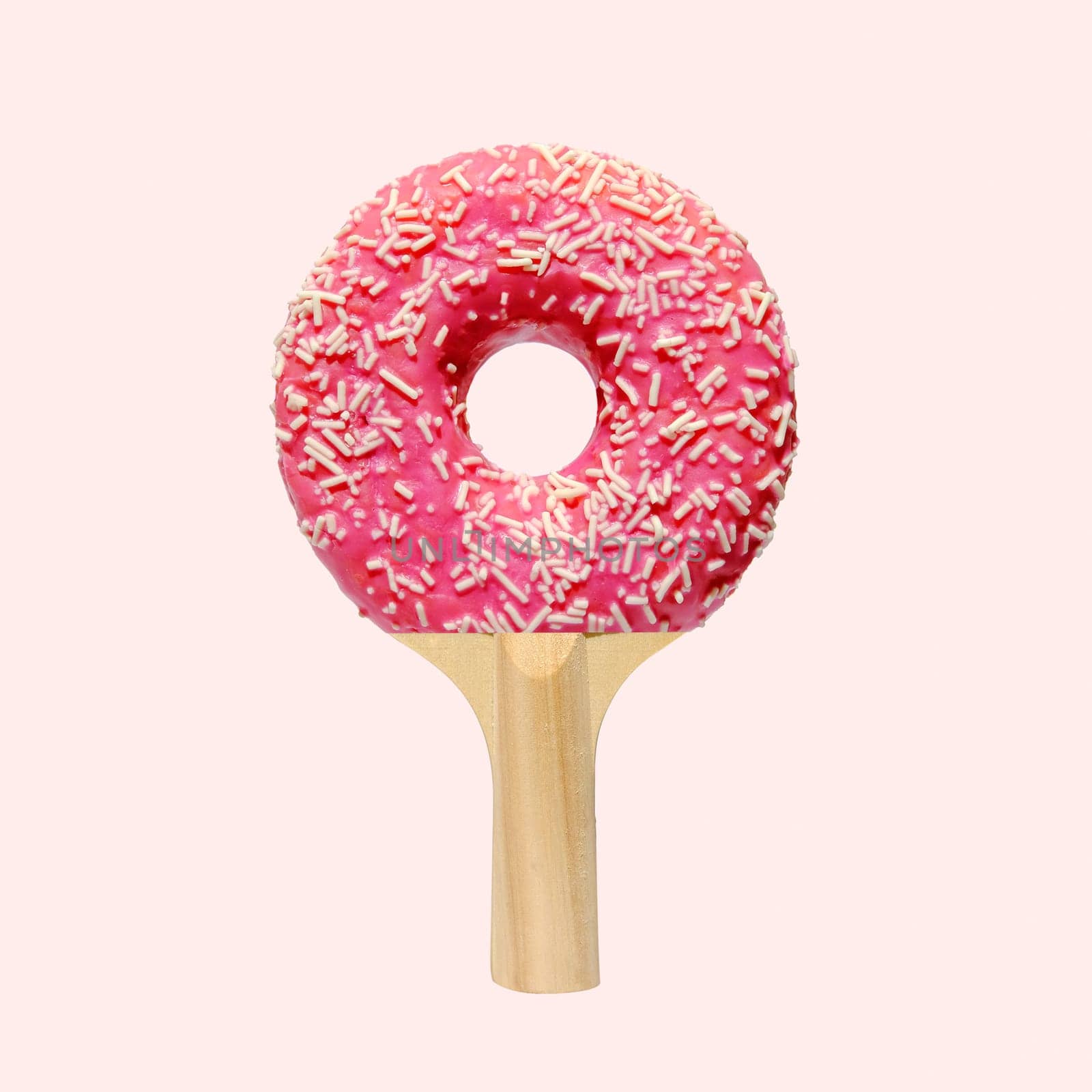 Playful collage with delicious pink donut and racket ping pong tennis. Minimal crazy creative idea. High quality photo