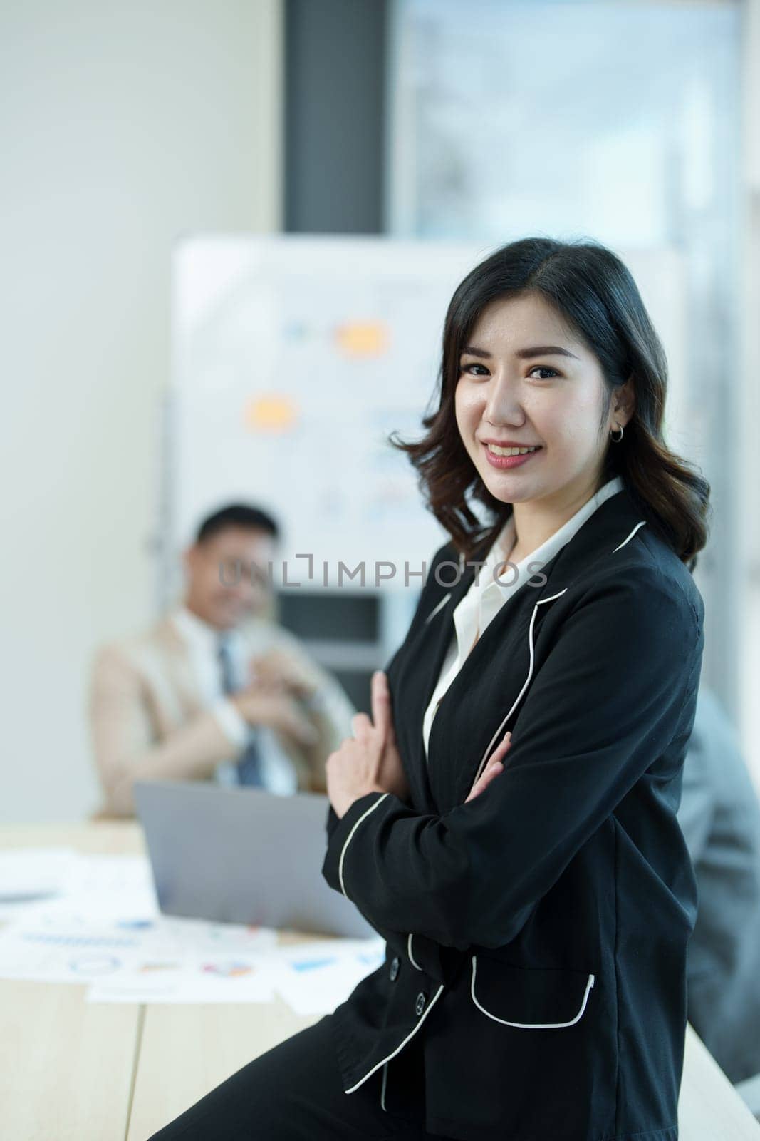 Portrait of a female business owner with a smiling face successfully invests his business in a conference room by Manastrong