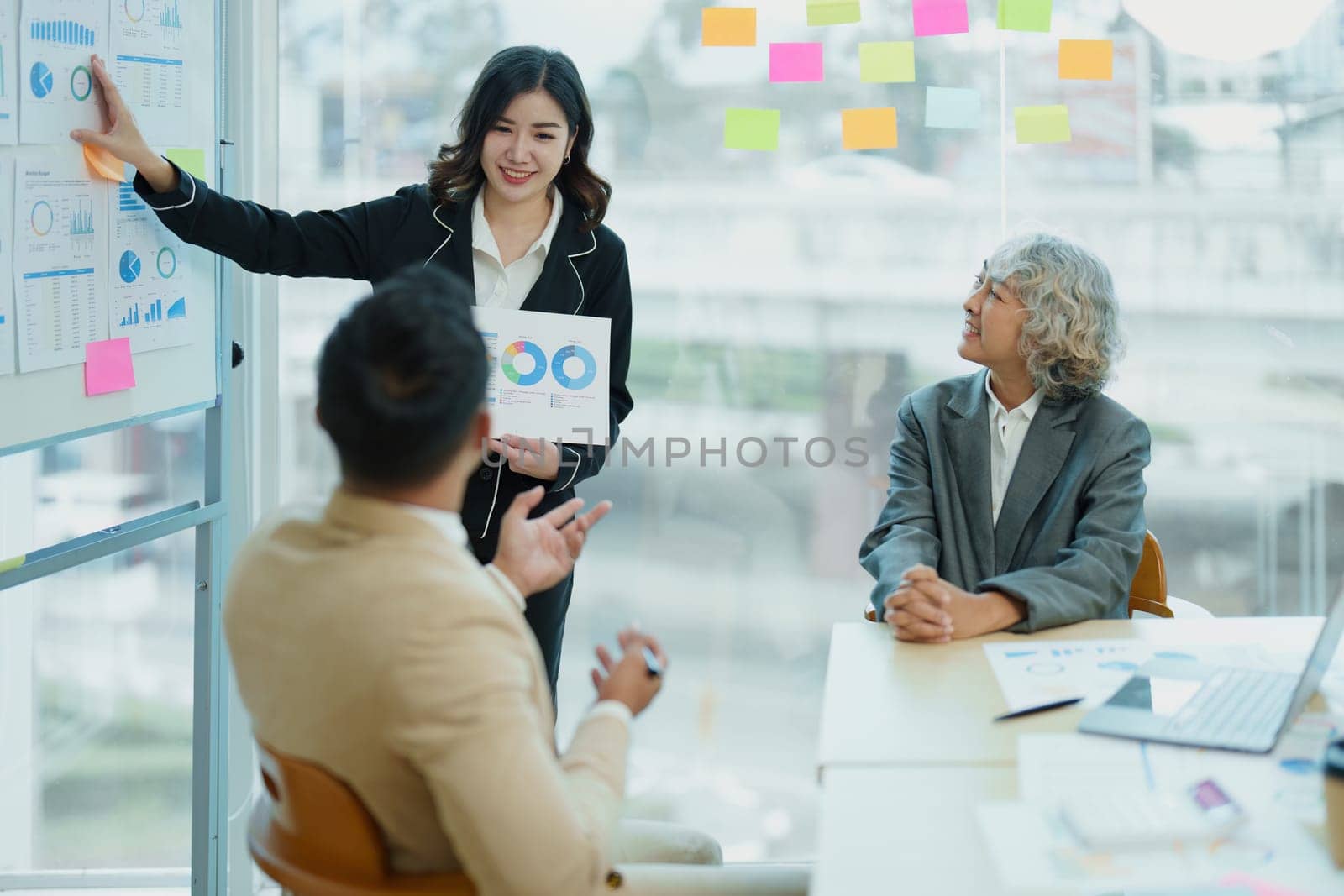 Asian entrepreneurs and business people meeting in a conference room in business planning, financial budget and investment risk assessment to analyze customer groups to increase company growth by Manastrong