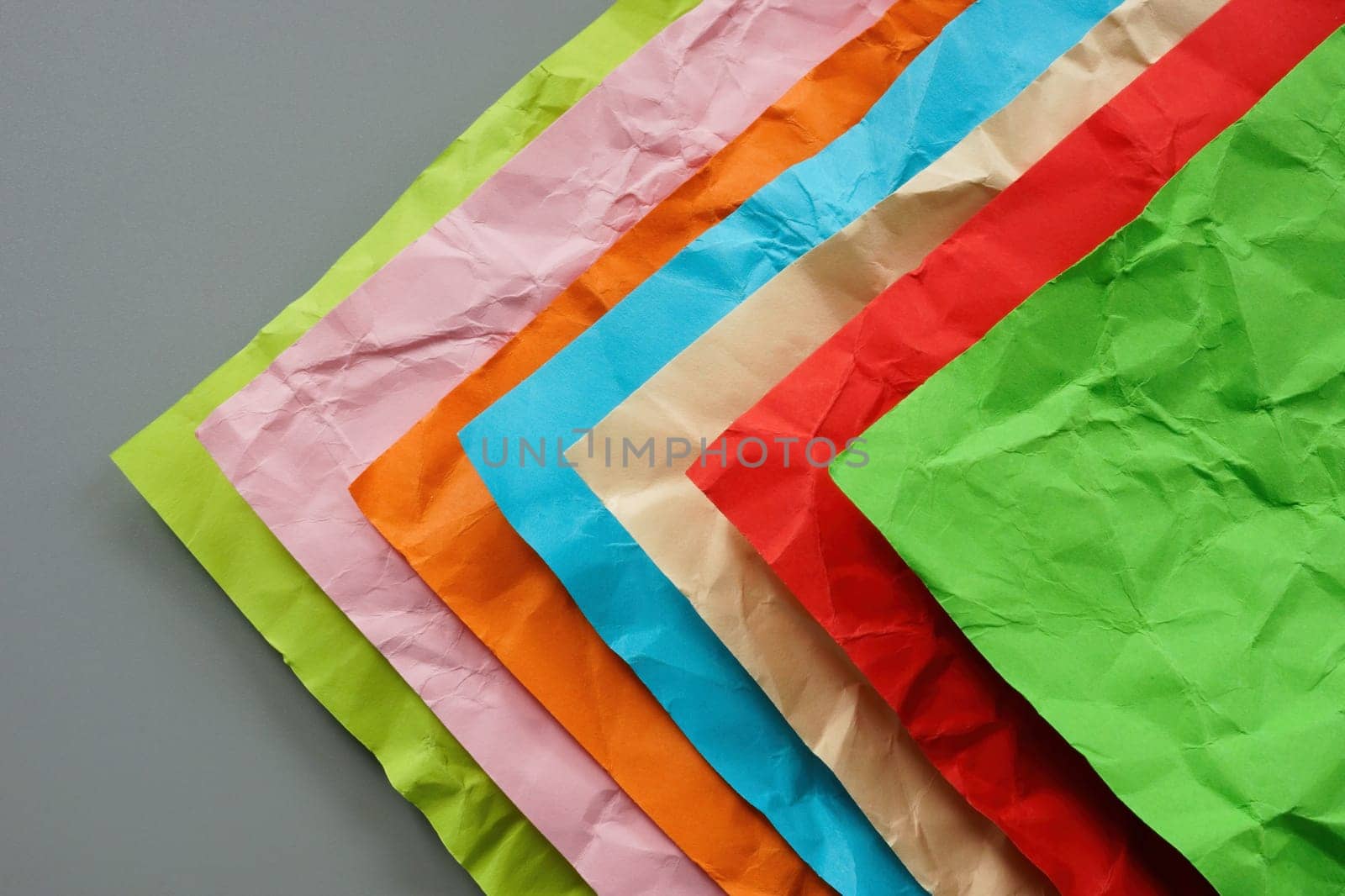 Multi-colored crumpled sheets of paper as a concept of diversity. by designer491