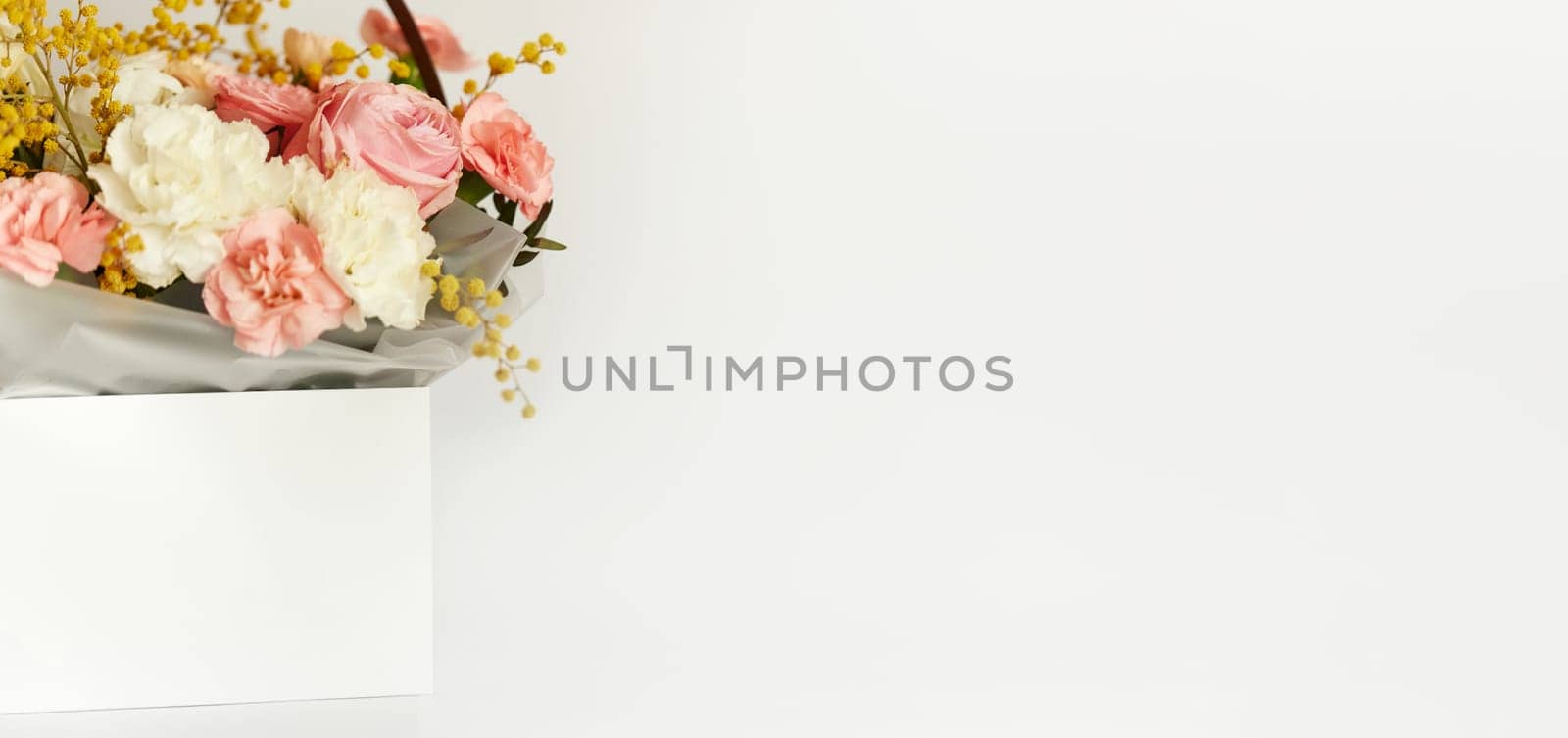 box with beautiful bouquet white and pink flowers on white background. Spring flowers. copy space