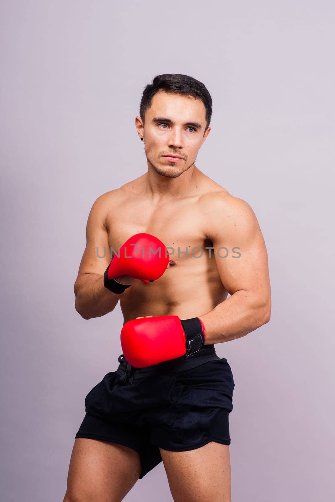 Boxing gloves, man training in sports fight, challenge or mma competition on studio background. by Zelenin