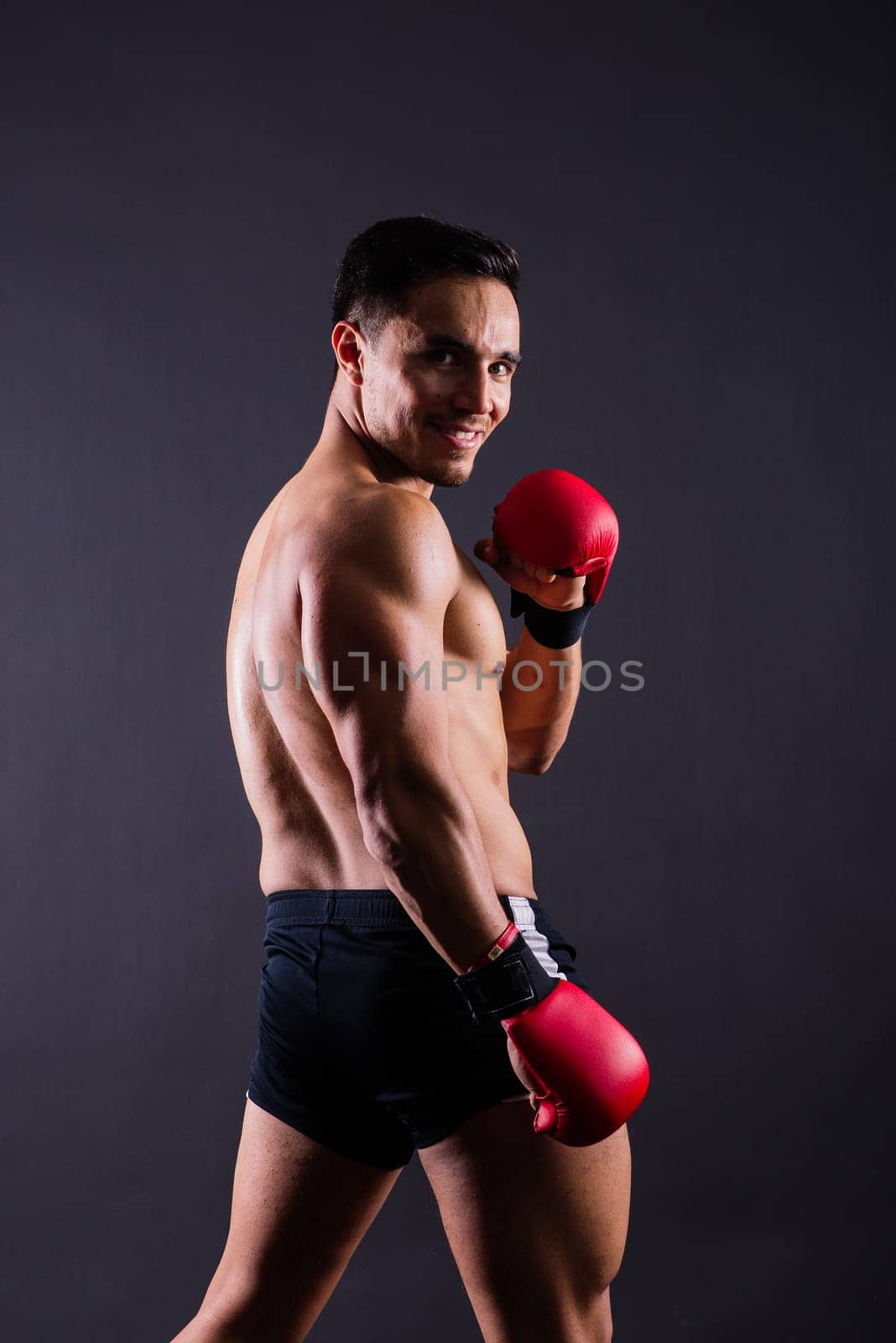 Boxing gloves, man training in sports fight, challenge or mma competition on studio background. by Zelenin