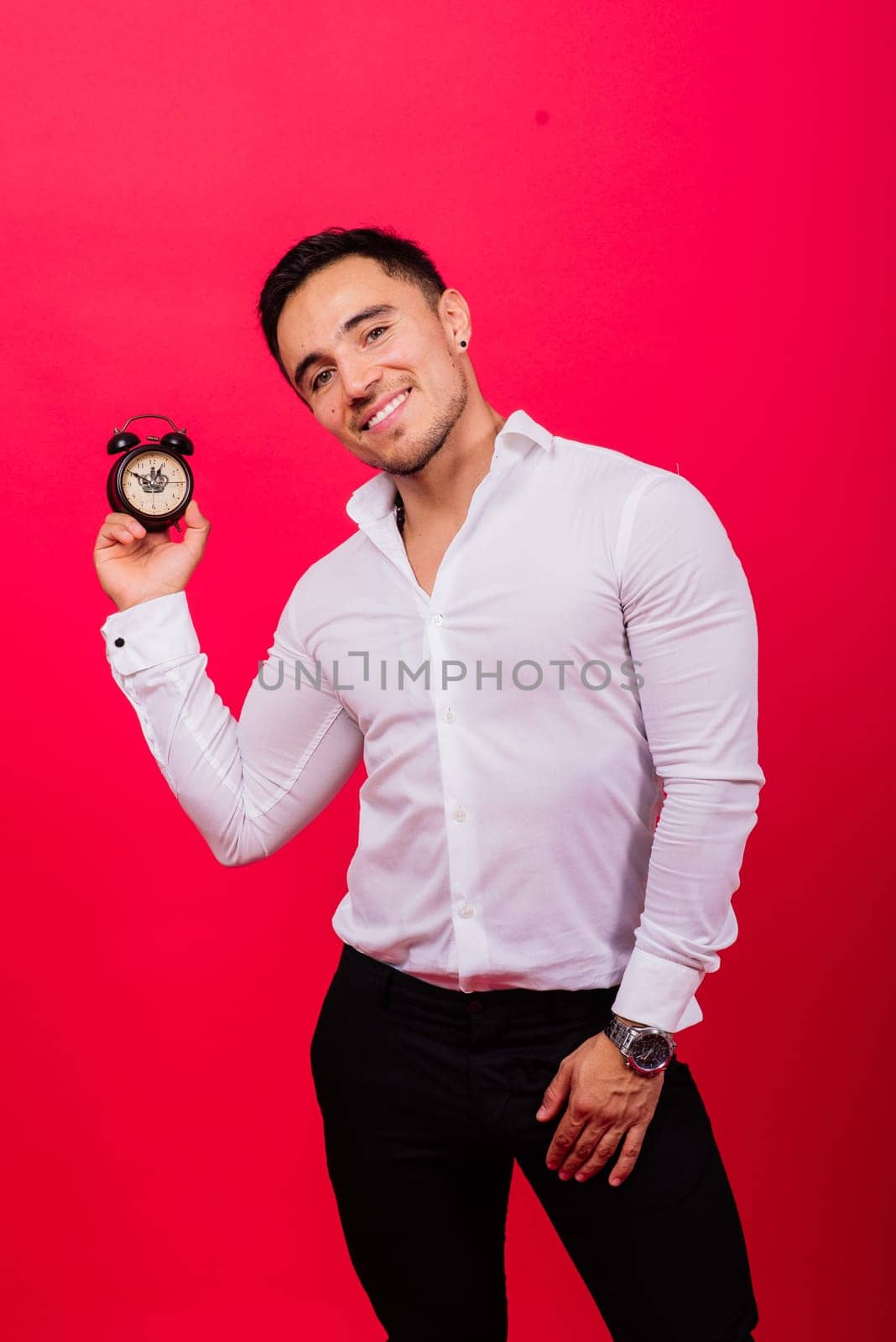 It is your time. Portrait of young man in showing time on a clock watch, ok, thumb up, approve