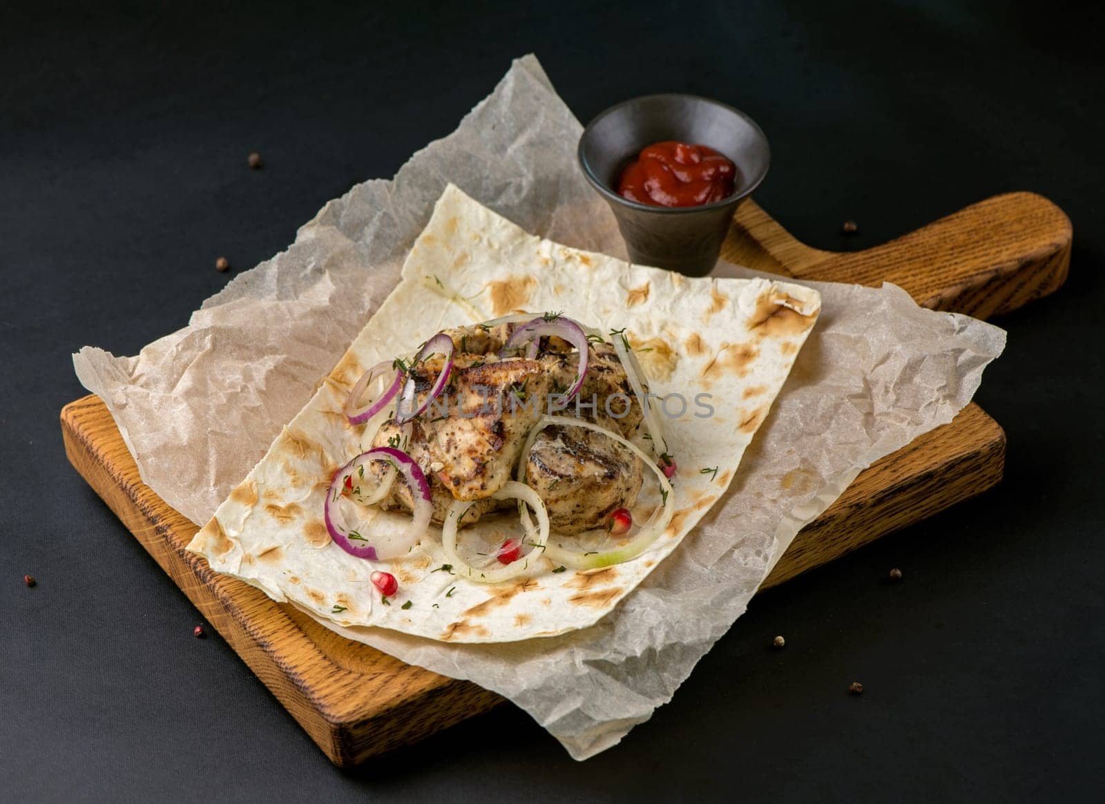 spicy grilled spare ribs on plate over dark stone background with copy space. Top view, flat lay