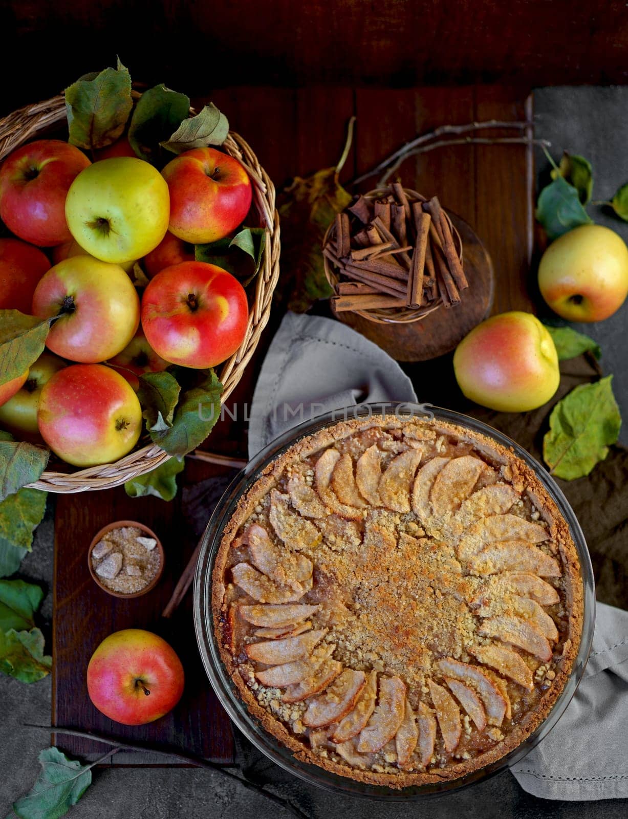 Home made apple pie with fresh fruits on a wooden table