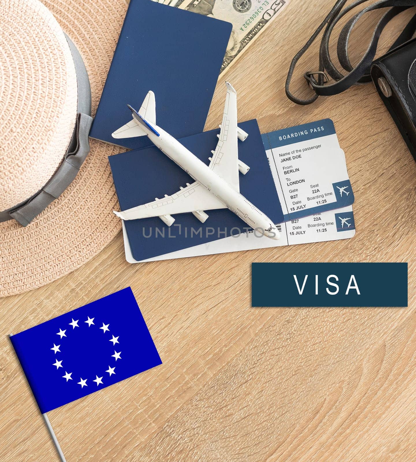 Flag of European Union with passport and toy airplane on wooden background. Flight travel concept by Andelov13