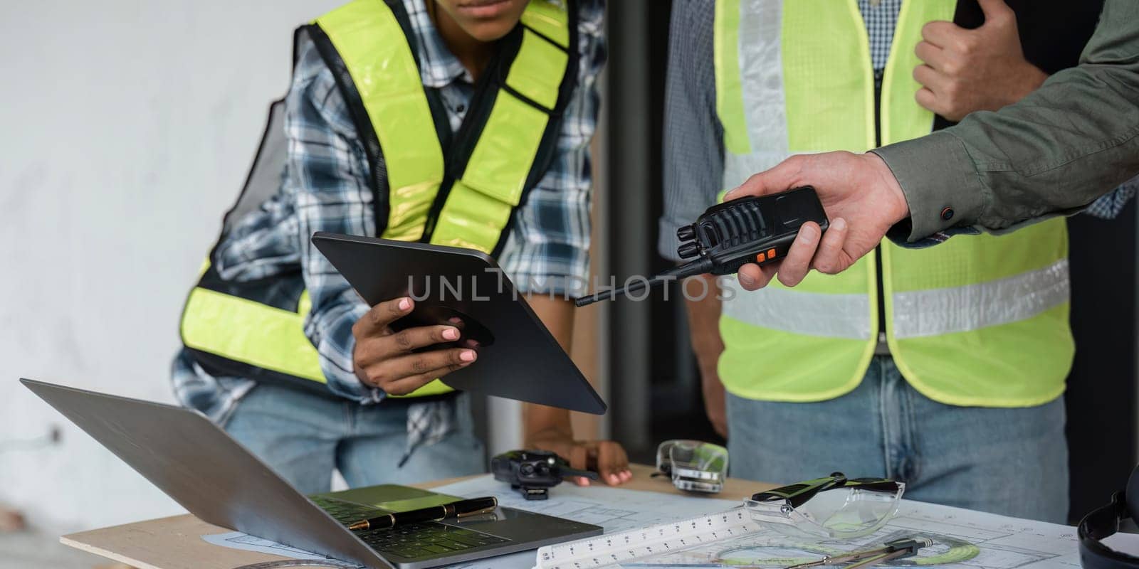 engineer working in office with blueprints , walkie talkie, tablet , laptop, inspection in workplace for architectural plan, construction project ,Business construction.