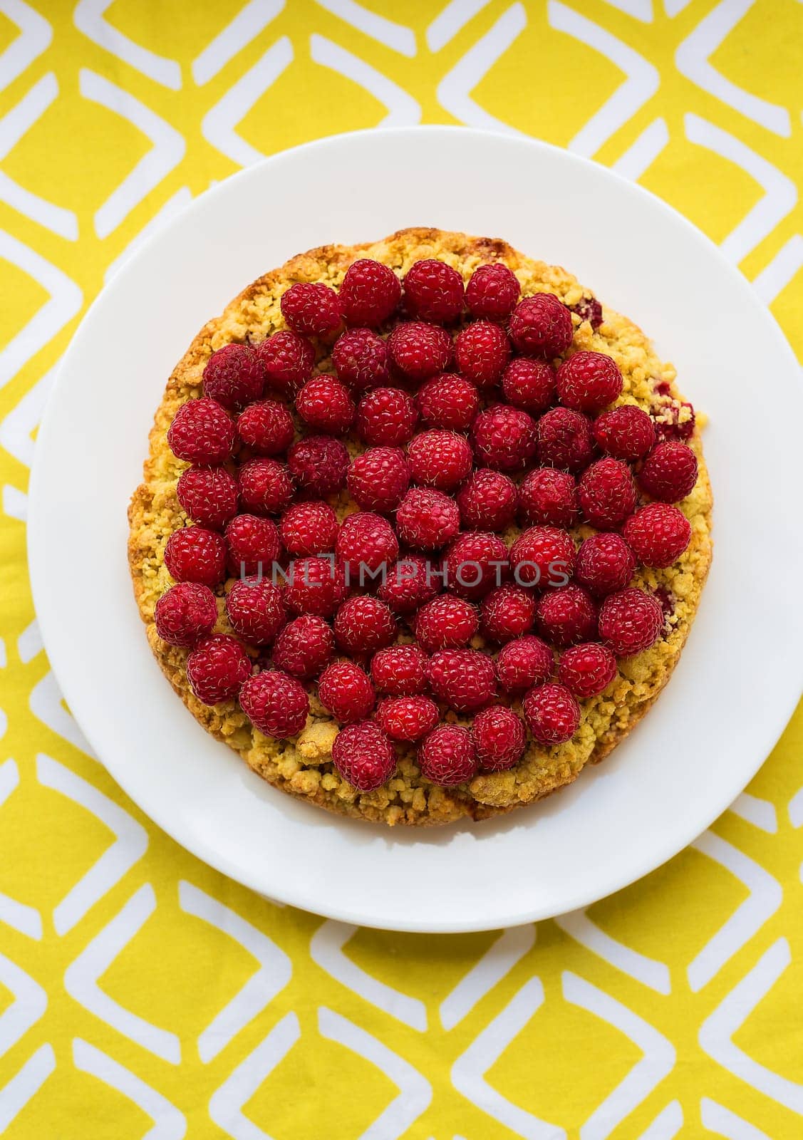 bright crimson-sand cake on yellow napkin, top view by sfinks