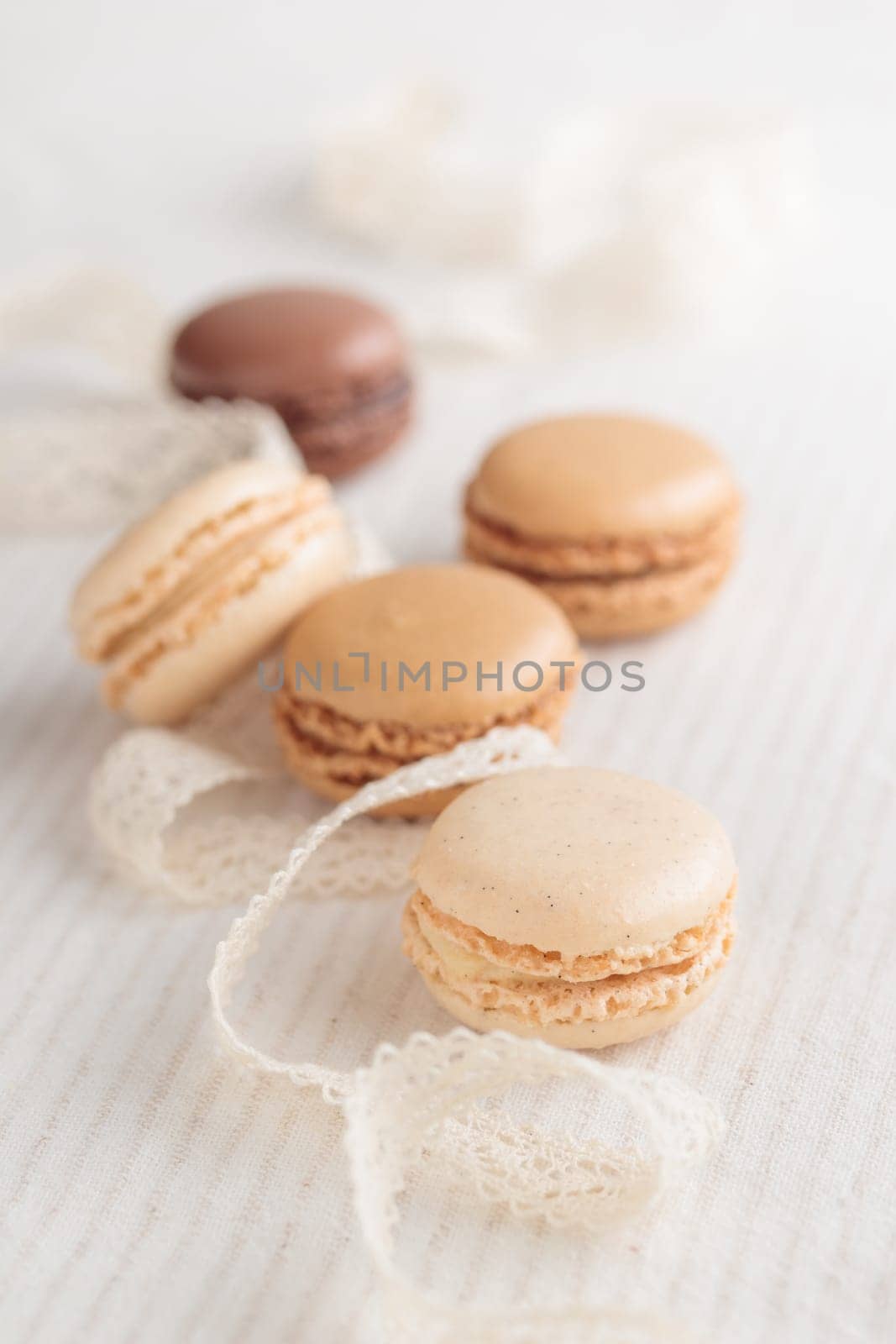 Colorful pastel eco handmade natural macaroons on white background. Gift for 8 March, International Women's Day, Valentine Day. Vertical photo