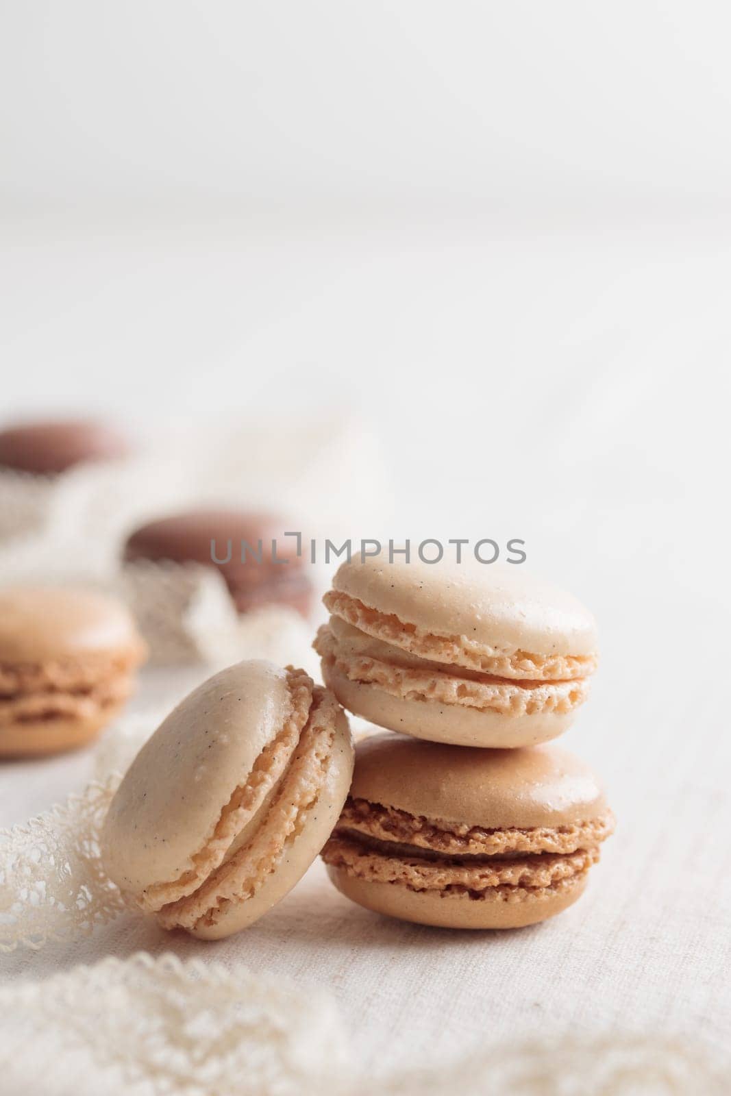 Colorful pastel eco handmade natural macaroons on white table. Gift for 8 March, International Women's Day, Valentine Day. Vertical stack