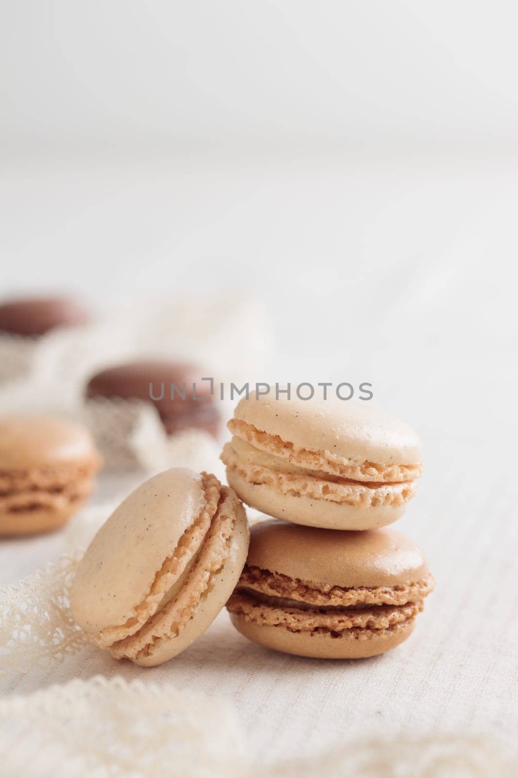 Colorful pastel eco handmade natural macaroons on white table. Gift for 8 March, International Women's Day, Valentine Day. Vertical stack