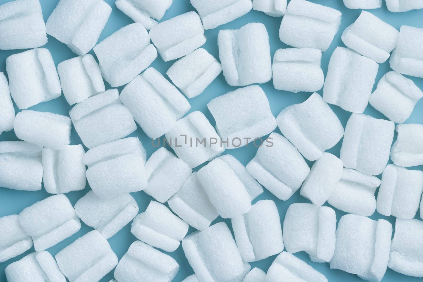 Styrofoam granules for filling boxe - reliable protective packaging solution, environmental friendly, fireproof and durable, shock-absorbing filler on a blue background