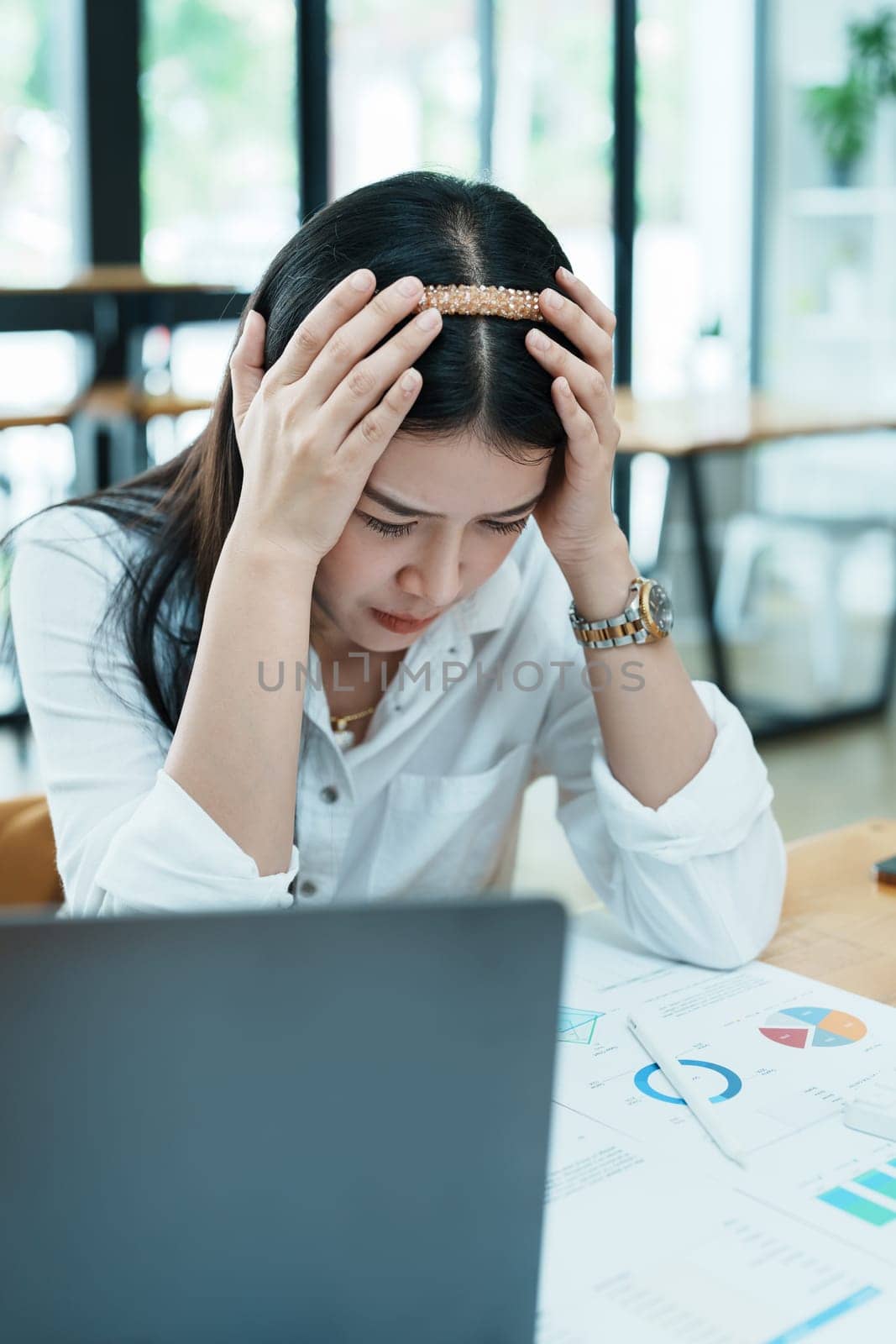 Portrait of sme business owner, woman using computer and financial statements Anxious expression on expanding the market to increase the ability to invest in business.