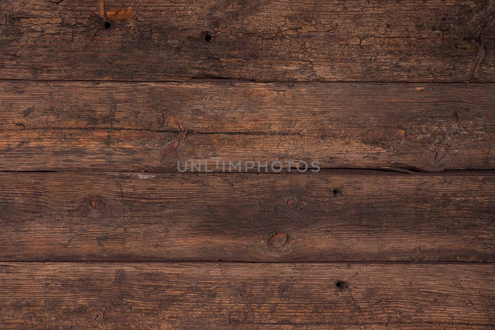 Several horizontally stacked old boards in clothes of brown color. Background of natural material slightly tattered.