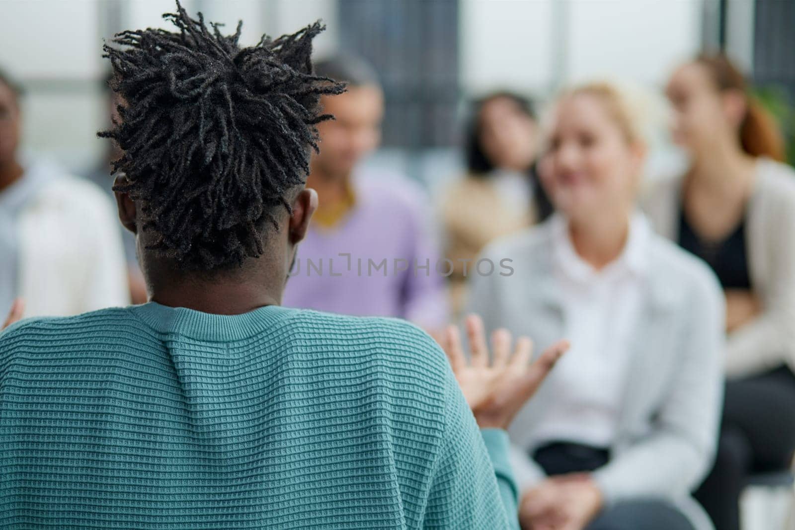 smiling man and woman talking while sitting on chairs