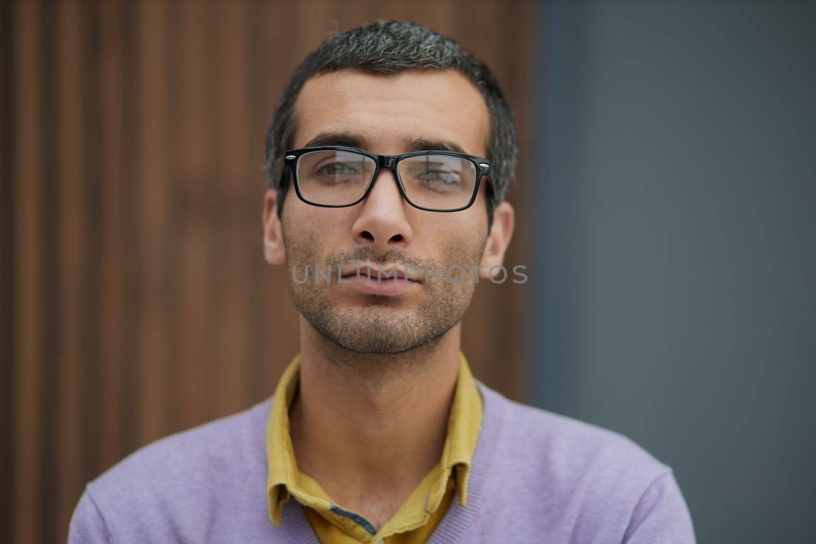 Handsome businessman standing with and looking at camera