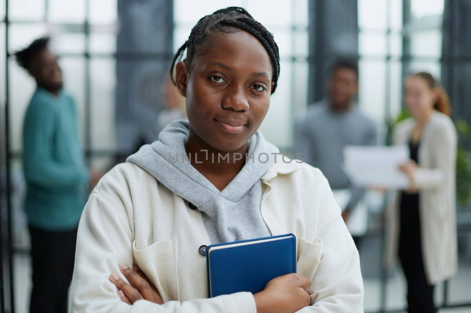 Attractive young office worker holding large file