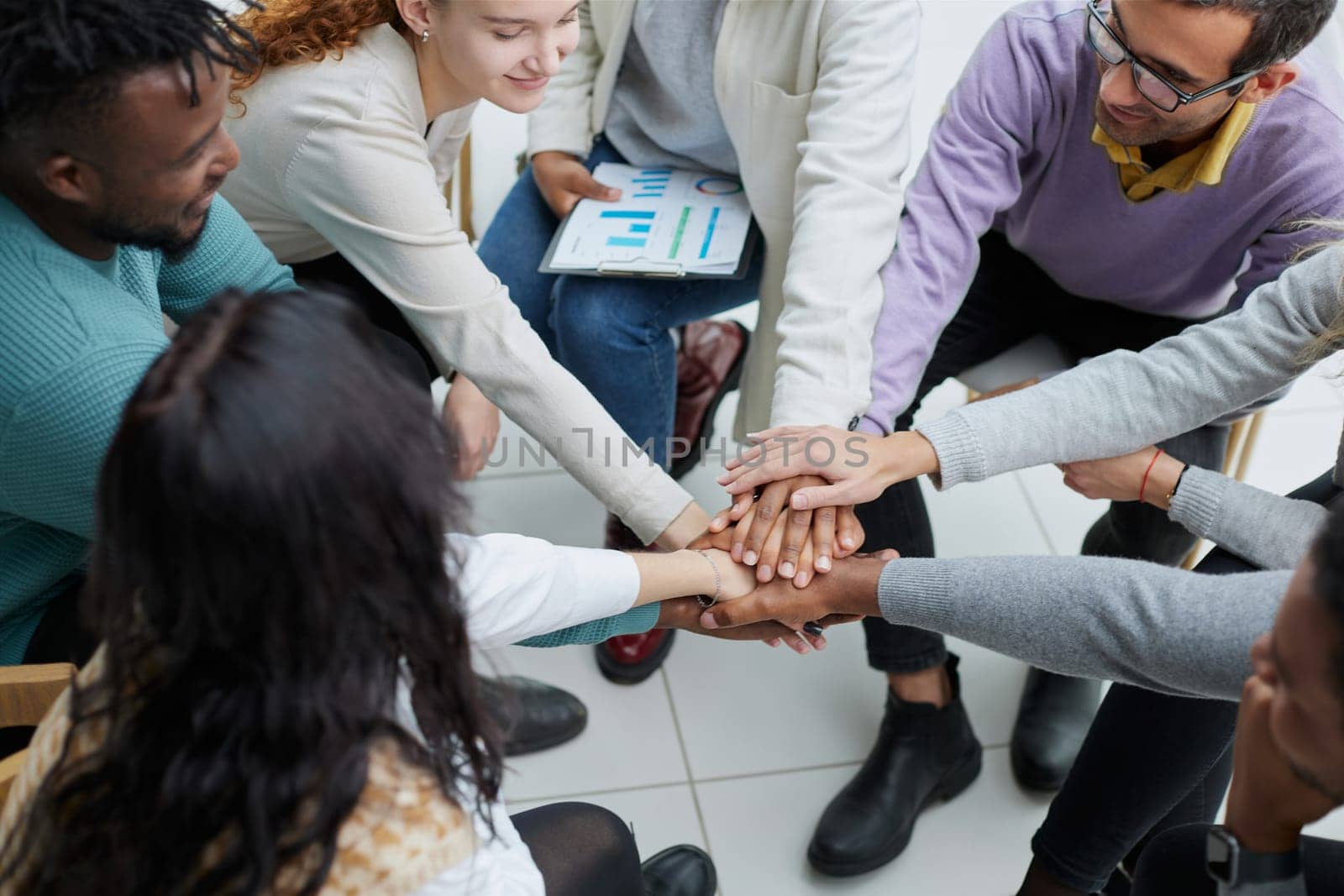 close-up of a business team sitting holding hands