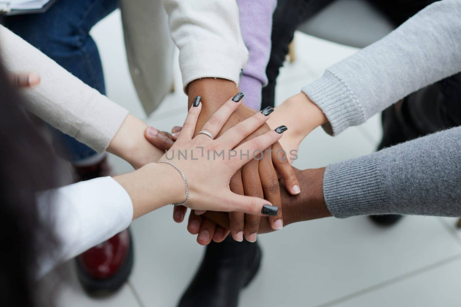 close-up of a business team sitting holding hands