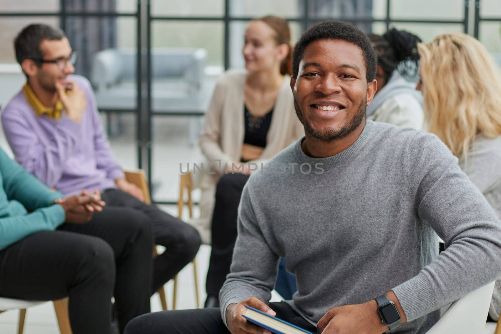 Gathered happy young businessmen holding negotiations, meeting with friendly diverse colleagues