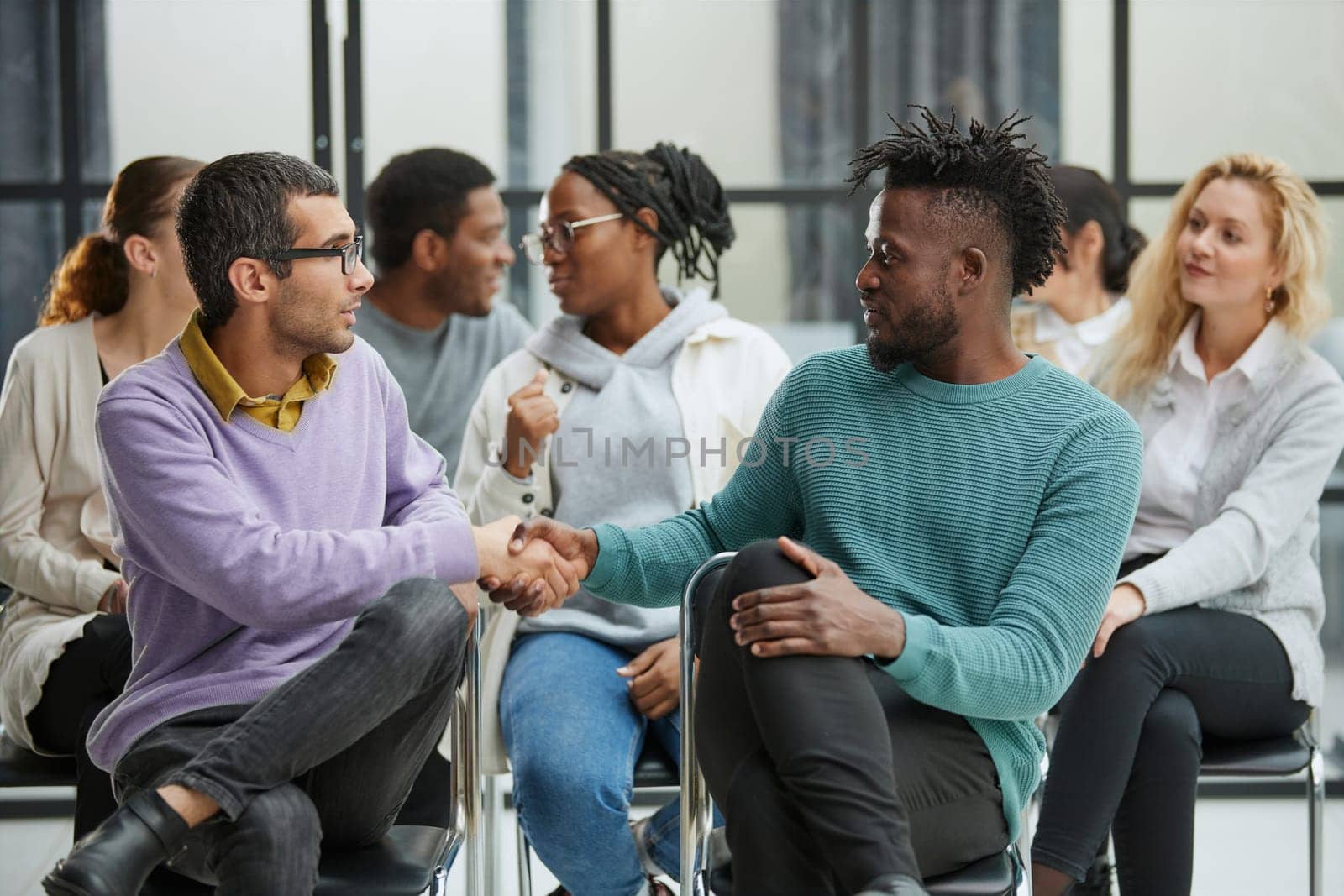 Positive people sitting on a chair, taking part in a team building or therapy session, trying to solve problems or doing training exercises