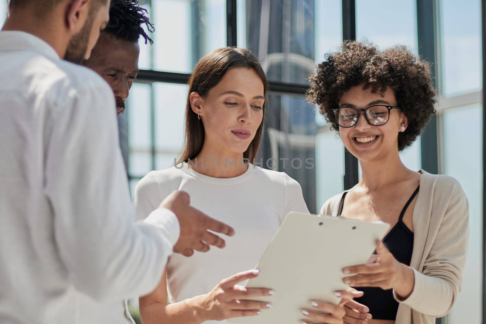 Employees working at computer together, discussing content by Prosto