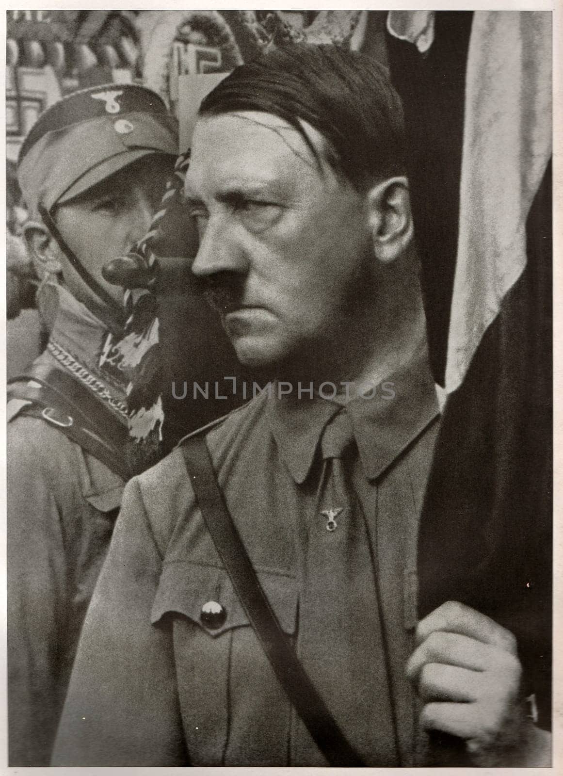 Adolf Hitler holds a standard during the Party Congress of the NSDAP in Weimar Republic. Reproduction of antique photo. by roman_nerud