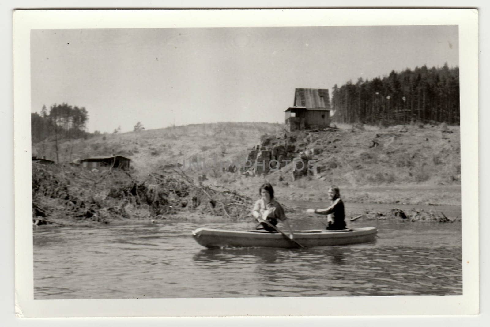 Vintage photo shows young canoeists on the river. by roman_nerud