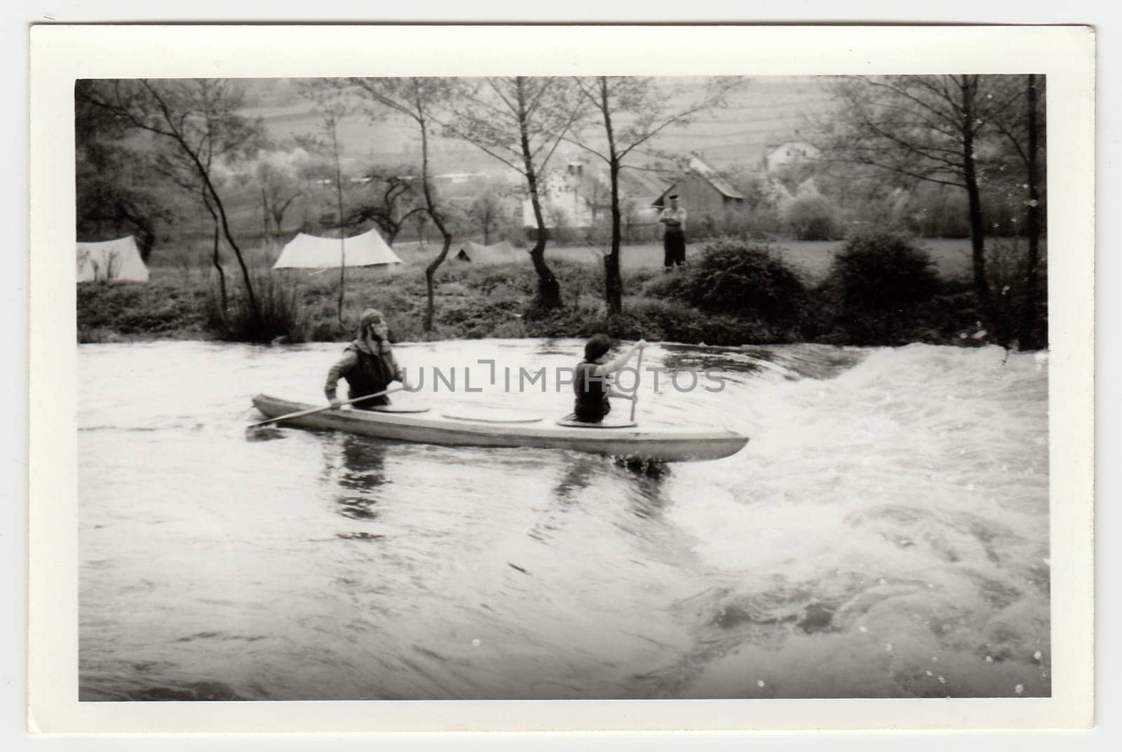 Vintage photo shows young canoeists on the river. by roman_nerud