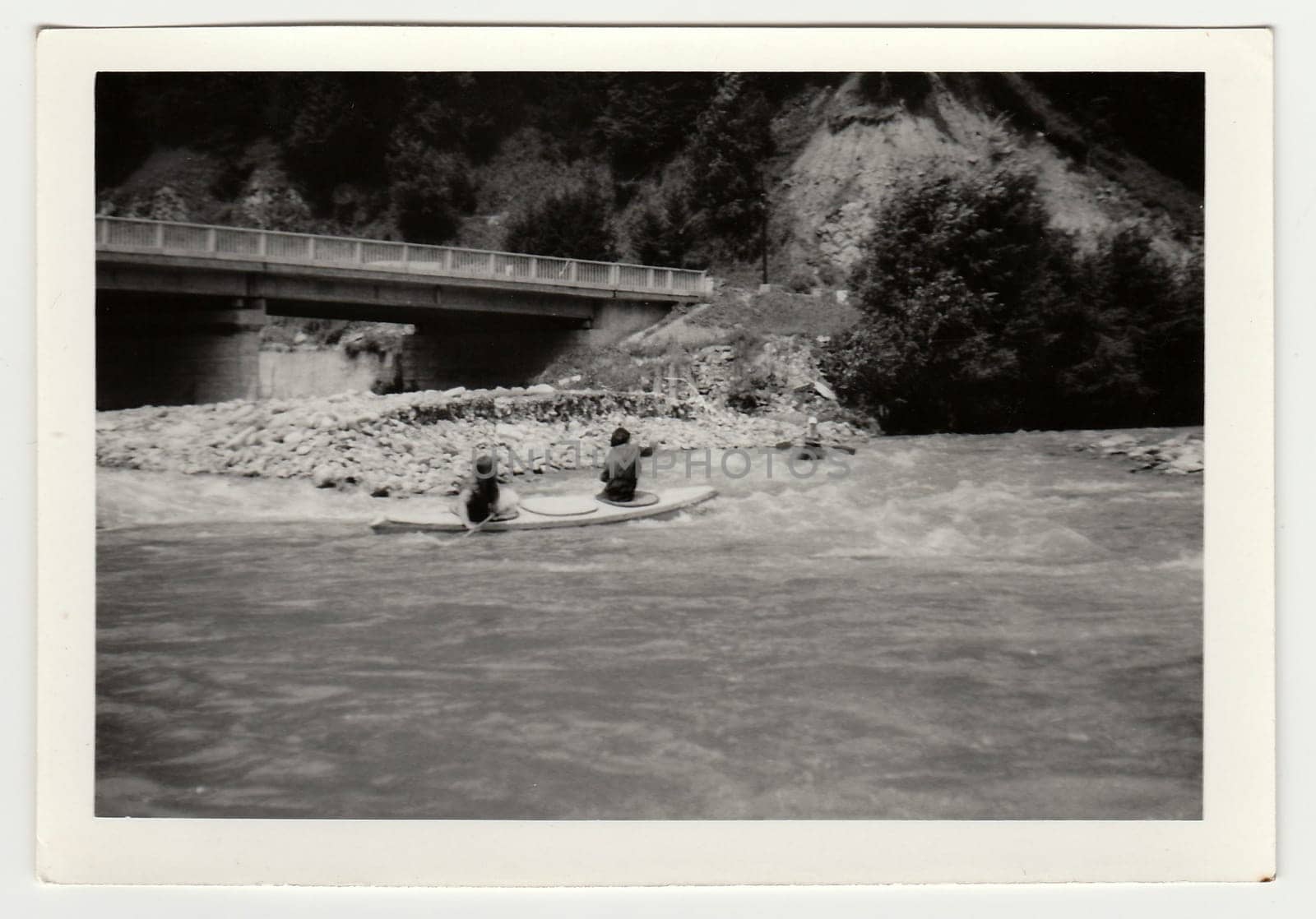 Vintage photo shows young canoeists on the river. by roman_nerud