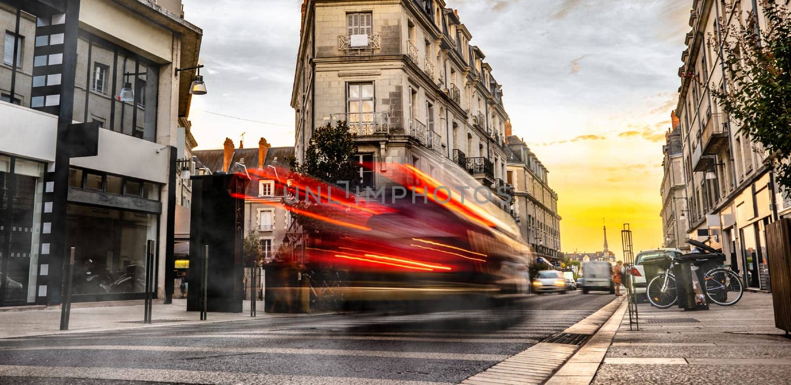 European street with car trails in the evening. Beautiful evening lights in city,