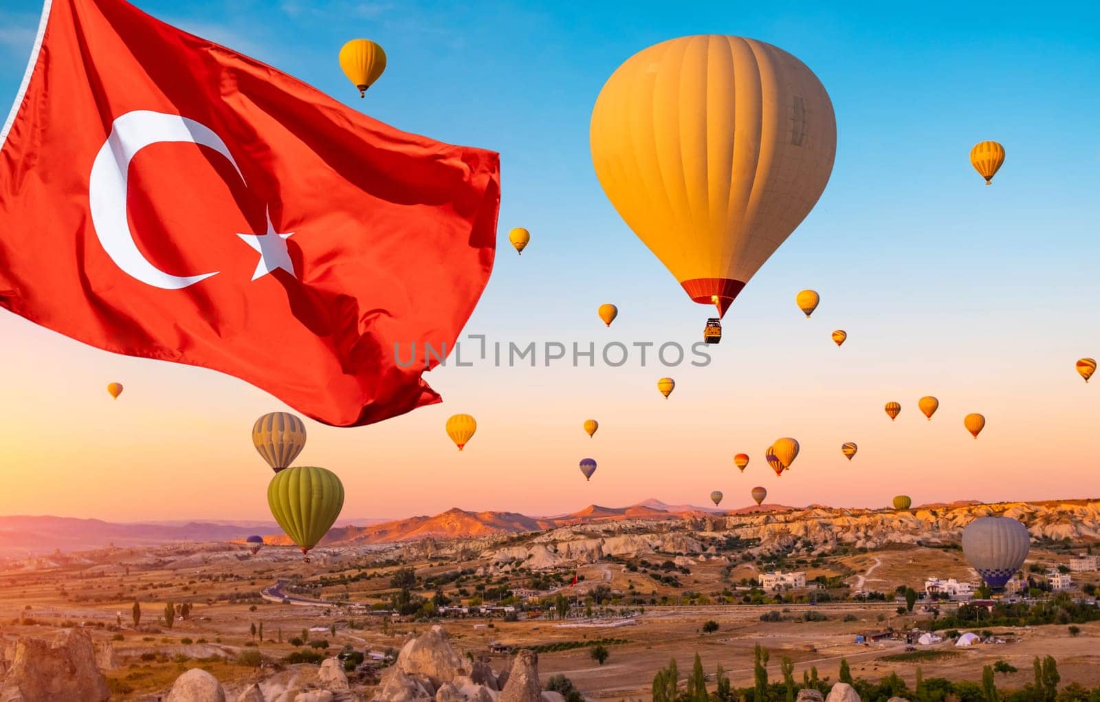 Turkey flag against hot air balloons in sky of Cappadocia, Turkey