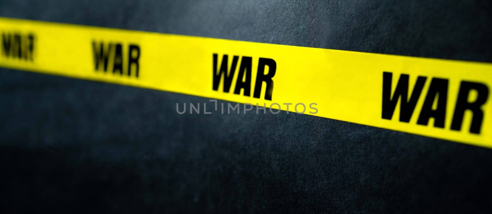 Yellow tape stripe with war text as warning stop millitary conflict. Concept of invasion, danger and truth