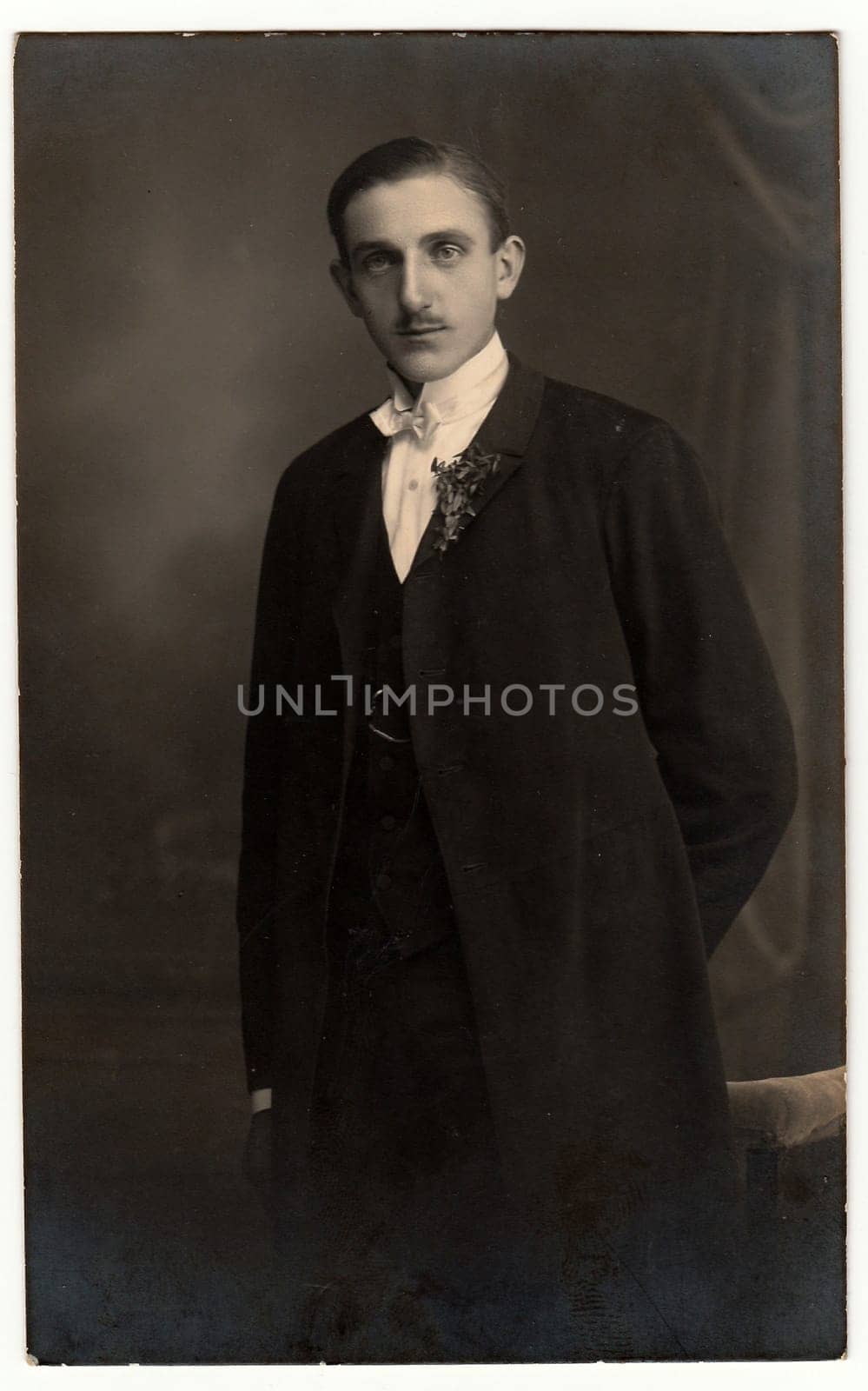 Vintage photo shows young groom wears dinner-jacket tuxedo . Antique black white photo. by roman_nerud