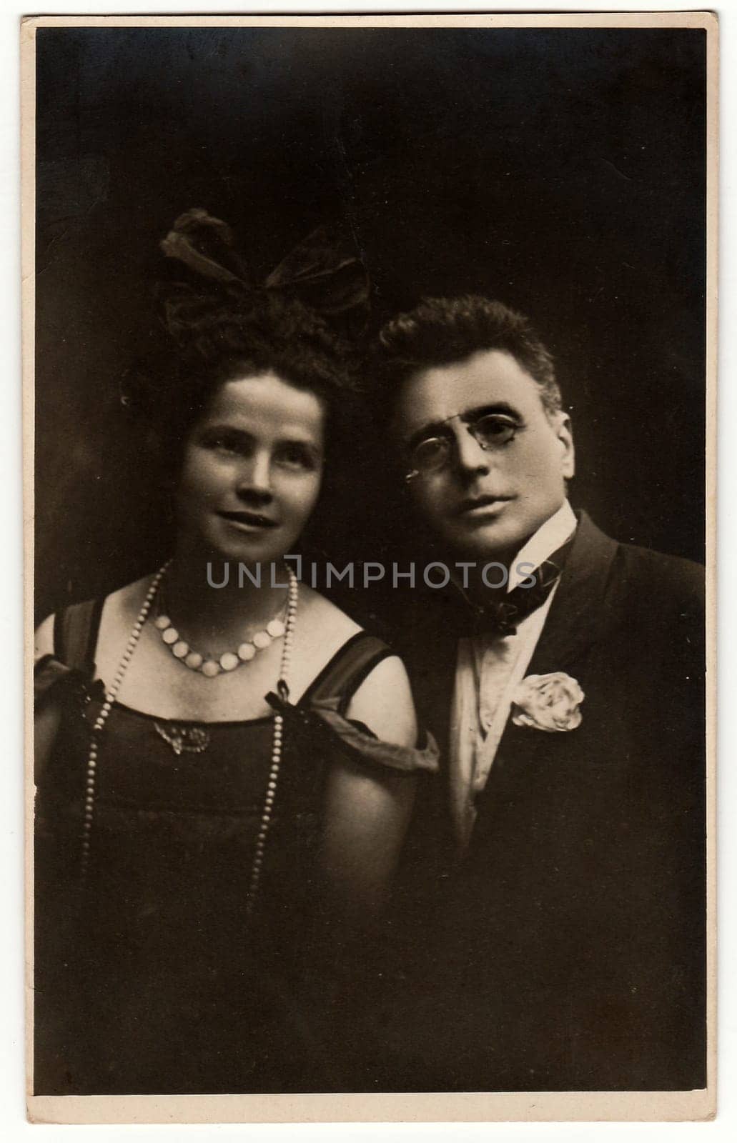 THE CZECHOSLOVAK REPUBLIC - CIRCA 1920s: Vintage photo shows a young couple. Antique black & white photo with dark tint.