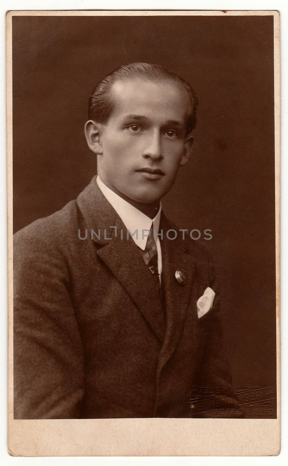 Vintage photo shows young man wears jacket. Antique black white studio portrait. by roman_nerud