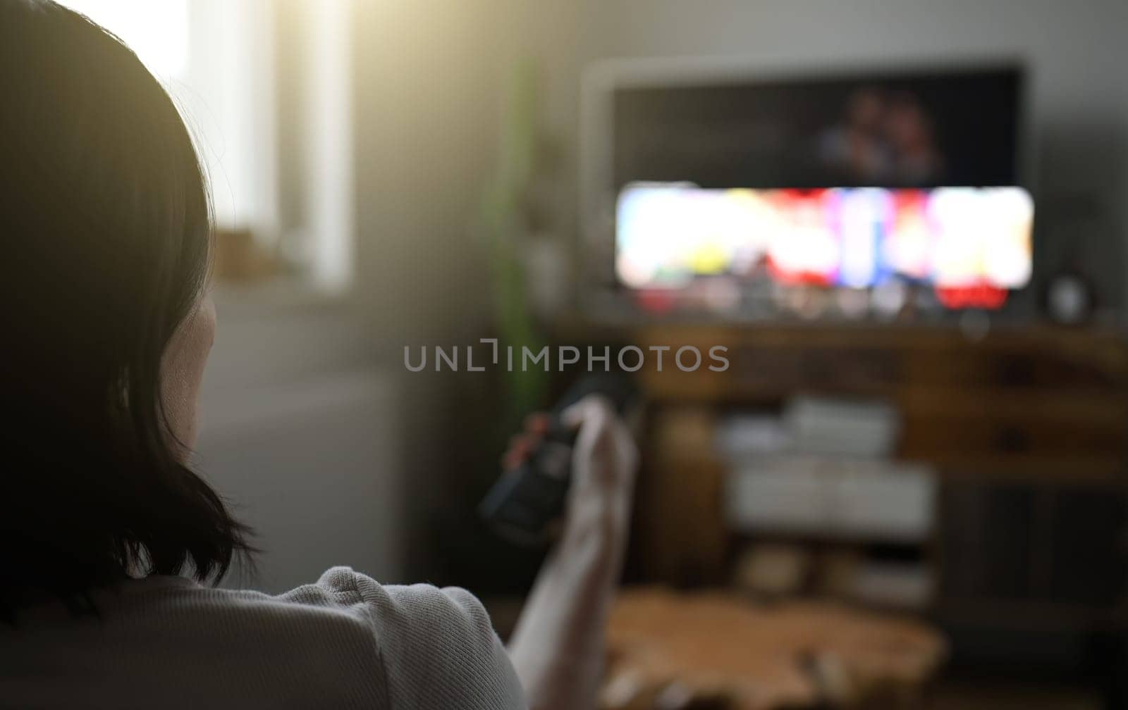 Woman watching television at home by GekaSkr