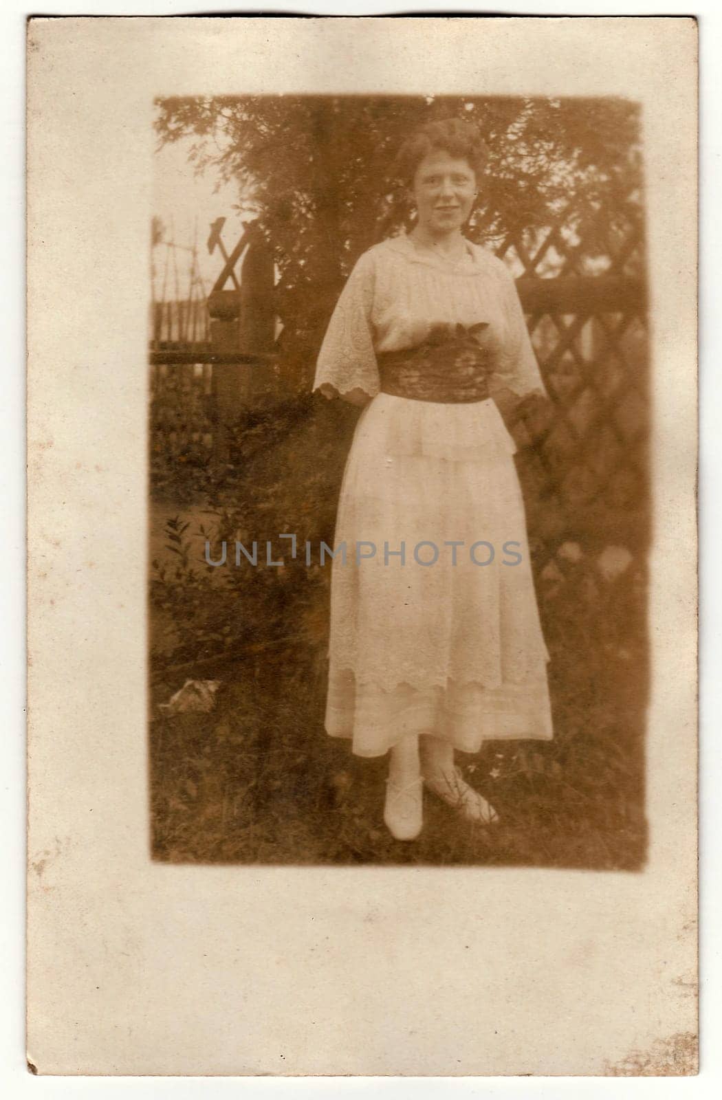 Vintage photo shows woman in the summer garden. Black white photo. by roman_nerud