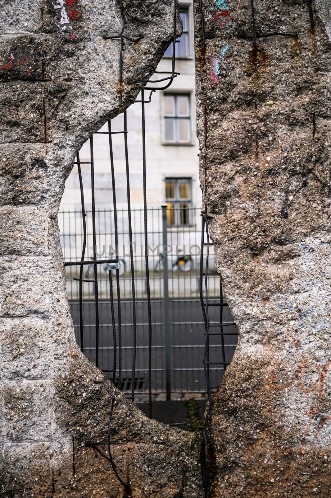 Hole in Broken Berlin wall between East and west Berlin, symbol of the Cold War. Concept of freedom and independence.