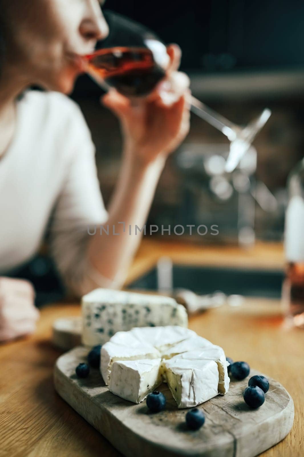 Women drinking a rose wine with french brie cheese by GekaSkr