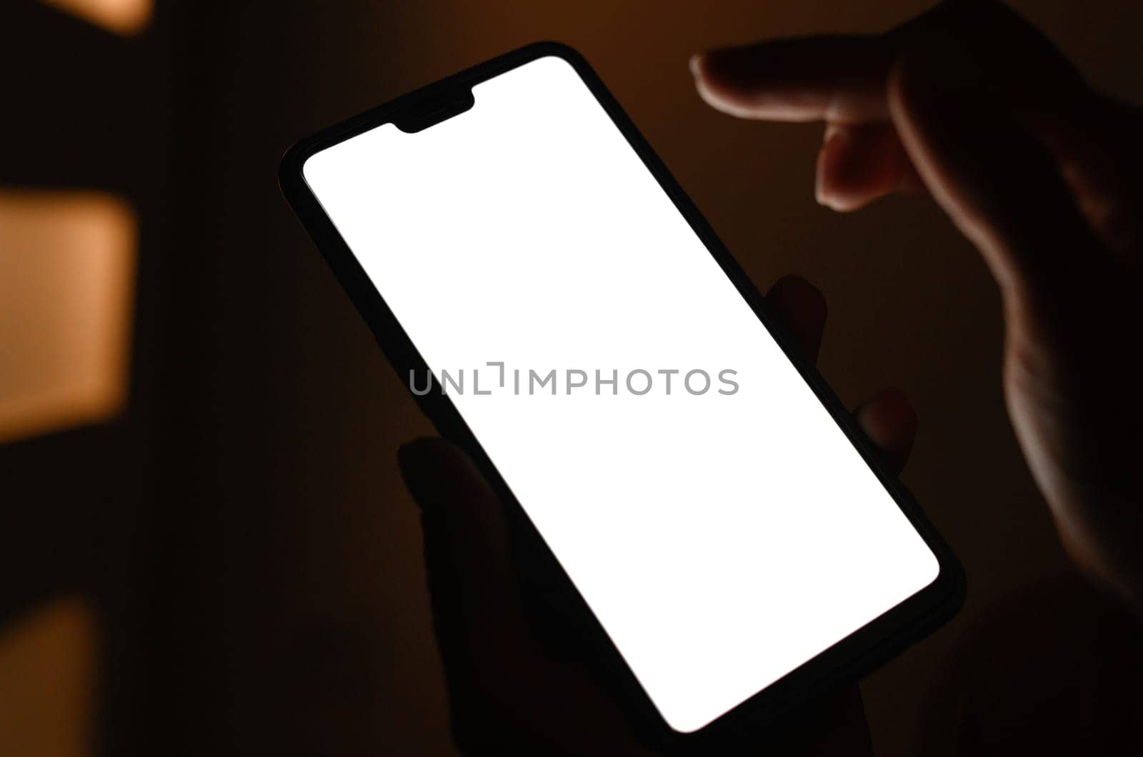 Hands holding a smart with white screen against blurry background